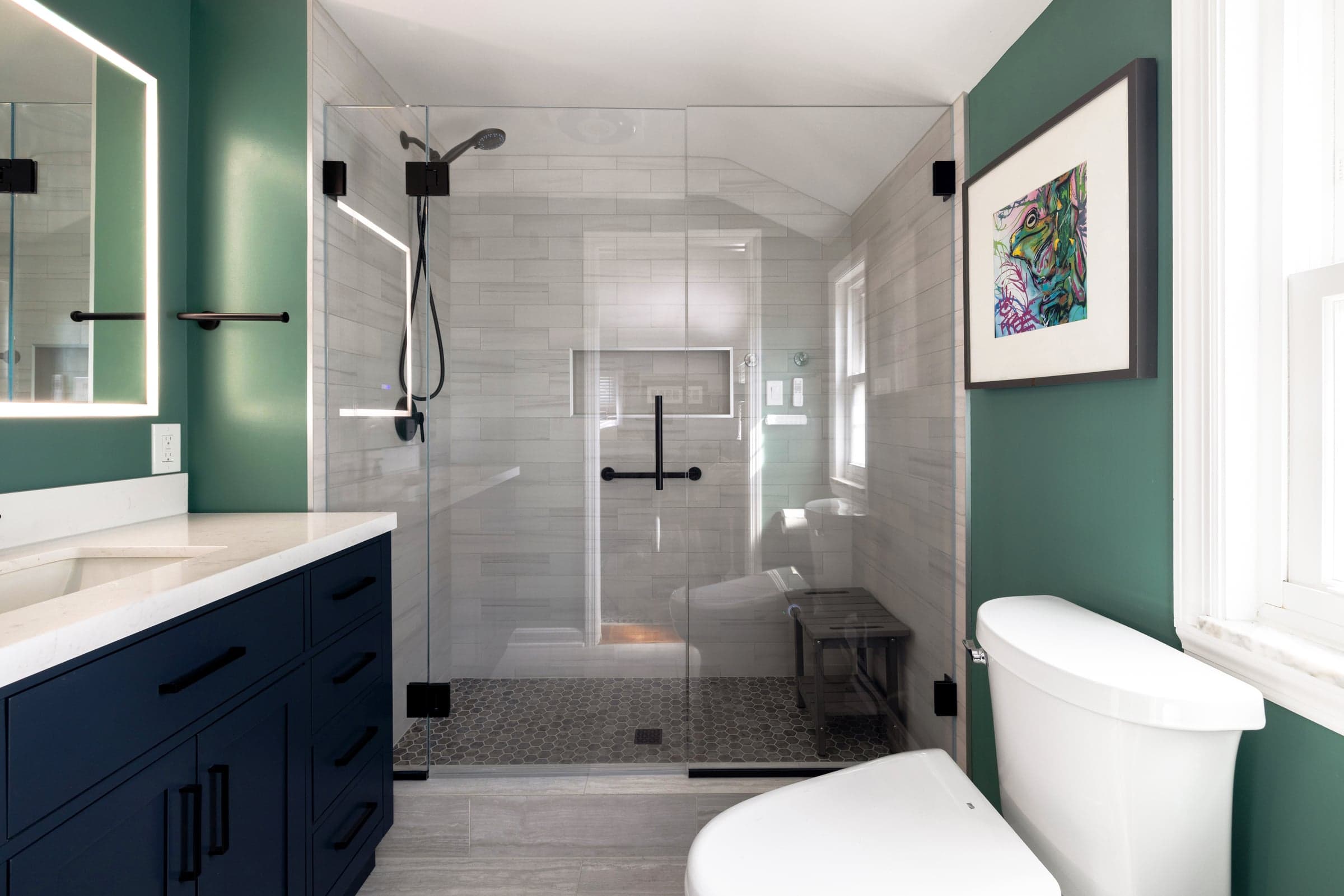 Warwick Street bathroom in Brookline — emerald walls, navy vanity, walk-in tile shower