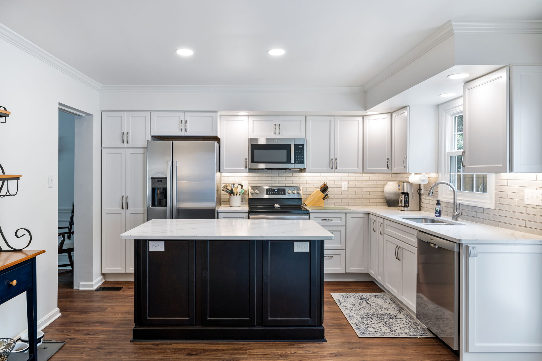 Modern white kitchen with dark island renovation