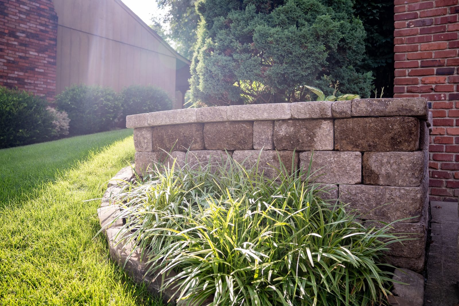 Block wall with ornamental grass landscaping